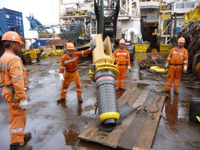 Workers handling a mooring connector in the Usan field