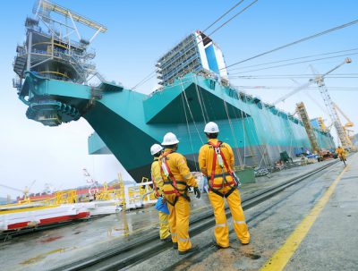Petronas workers stand near the PFLNG, photo courtesy of Petronas